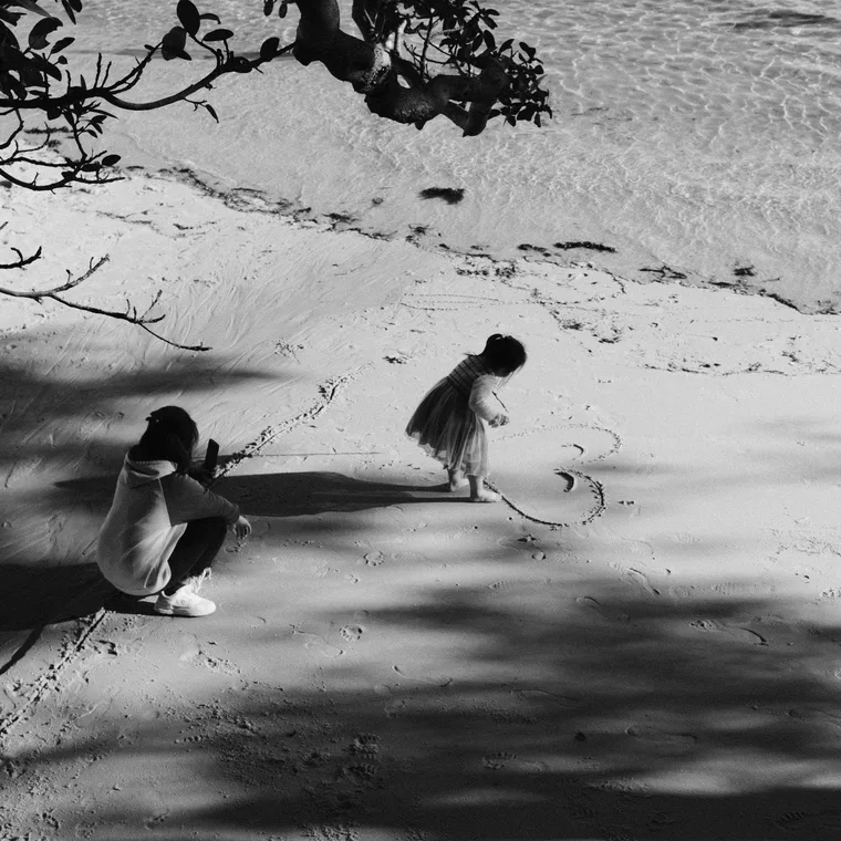 Children drawing in the sand